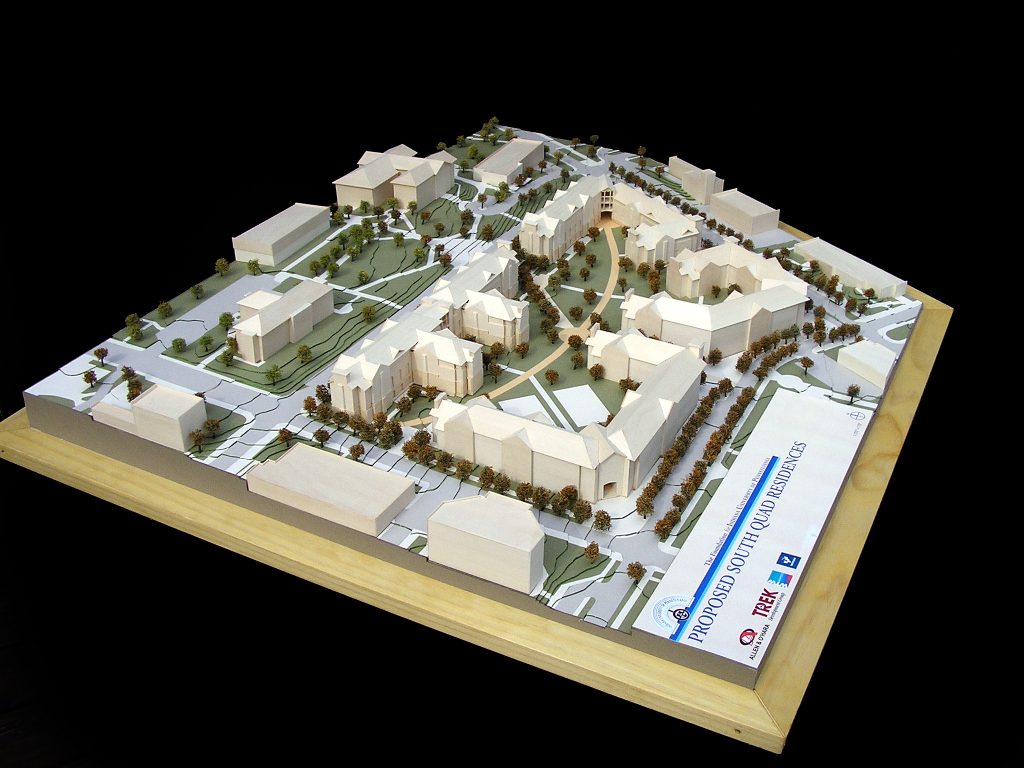 Model of campus with new student housing buildings, trees, roads, and topography