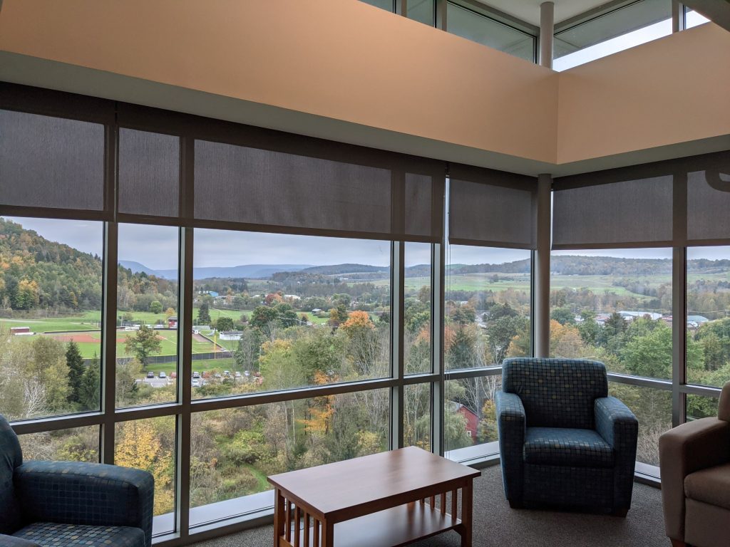 Living Room with floor to ceiling glass windows overlooking surrounding mountainside in Pennsylvania
