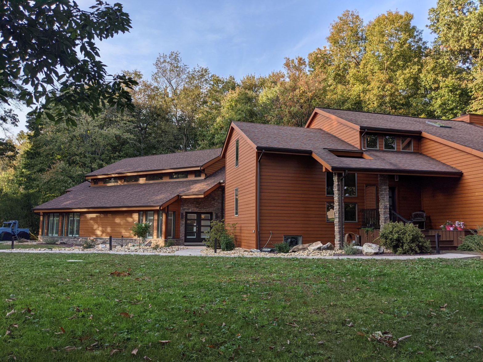 Exterior View of residential, dream home, creative design, modern, sustainable home, Contemporary House addition with stone, wood siding for an indoor pool